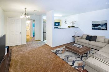 a living room filled with furniture and a flat screen tv at Dronfield Astoria Apartments, Sylmar